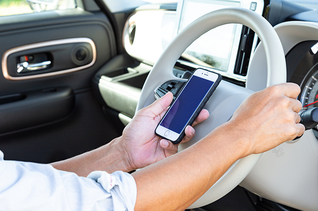 スマホを見ながら運転するドライバー